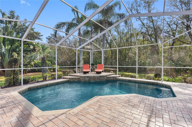 view of pool featuring a patio and glass enclosure