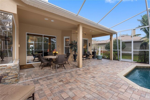 view of patio / terrace featuring a lanai and ceiling fan