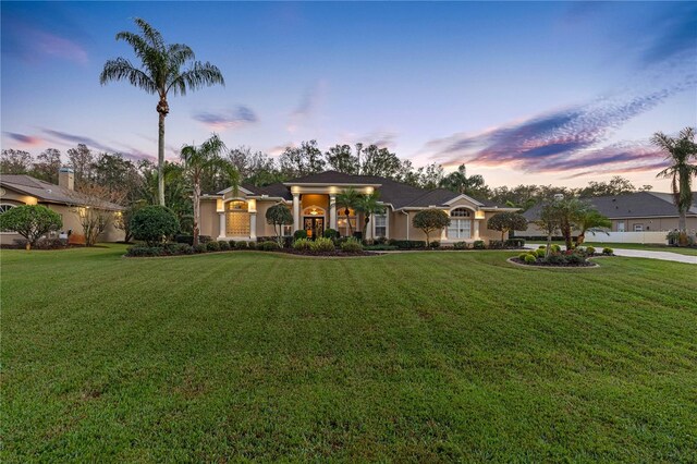 ranch-style home with a yard