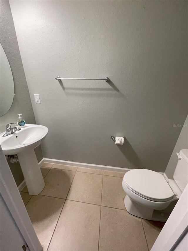 bathroom featuring toilet and tile patterned floors