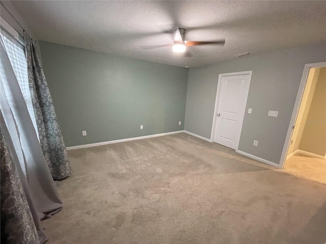 unfurnished bedroom featuring carpet flooring, ceiling fan, and a textured ceiling