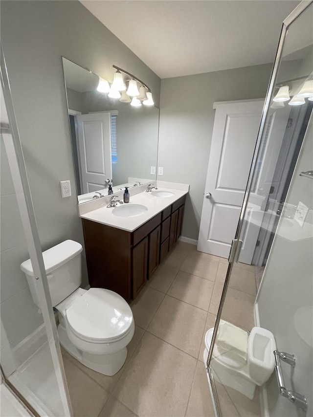 bathroom with tile patterned flooring, vanity, and a shower with door