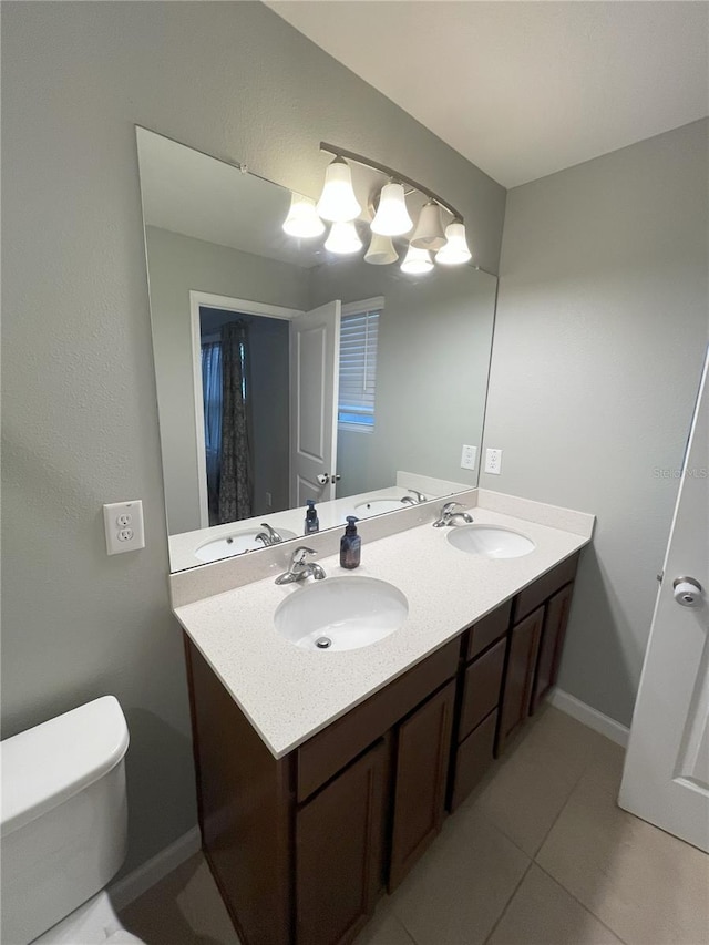 bathroom featuring tile patterned flooring, vanity, and toilet