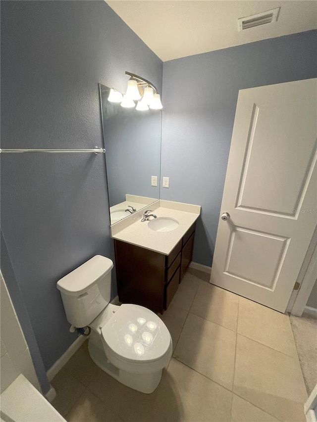 bathroom featuring tile patterned flooring, vanity, and toilet