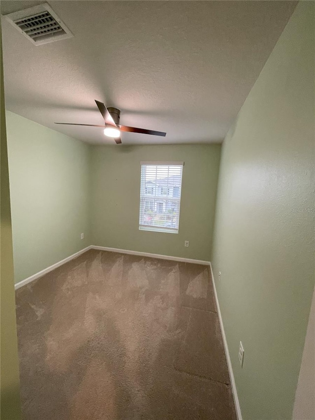 carpeted empty room with a textured ceiling