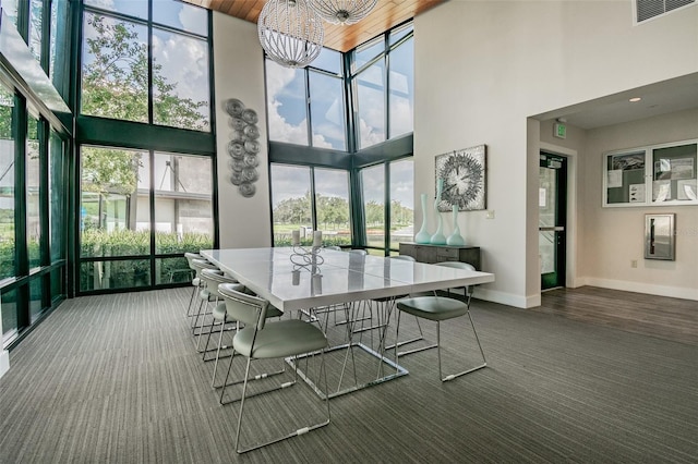 sunroom featuring a wealth of natural light and an inviting chandelier