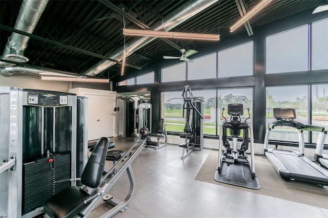 workout area featuring ceiling fan and high vaulted ceiling