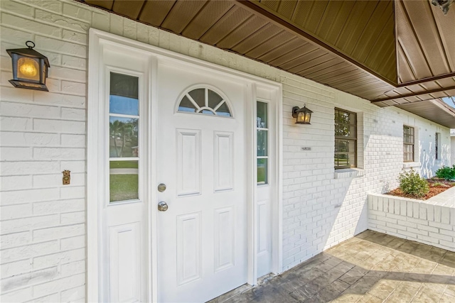 view of exterior entry with a porch