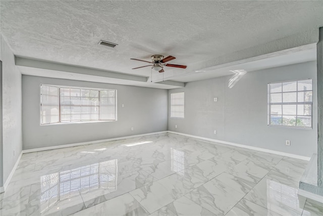 unfurnished room featuring ceiling fan and a textured ceiling