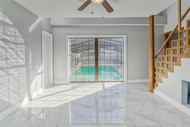 interior space featuring a textured ceiling and ceiling fan