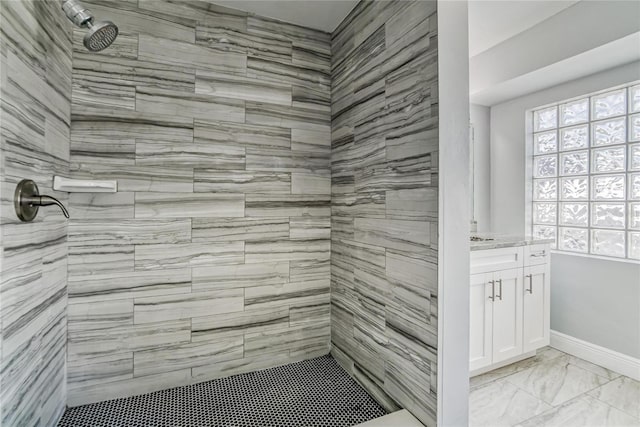 bathroom with vanity and tiled shower