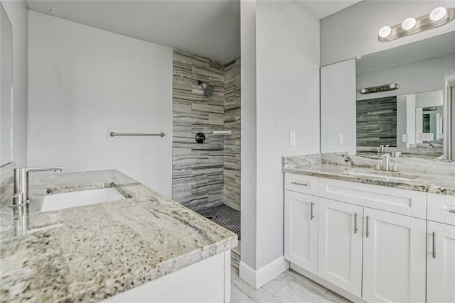 bathroom featuring vanity and tiled shower