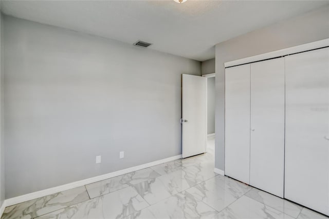 unfurnished bedroom with a closet