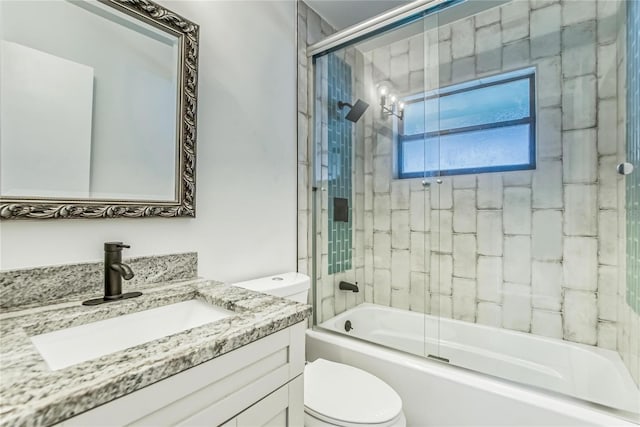 full bathroom featuring shower / bath combination with glass door, vanity, and toilet