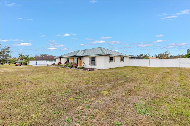 rear view of property with a yard