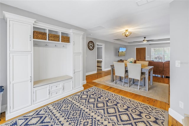 dining space featuring ceiling fan and light wood-type flooring