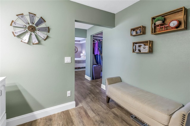 corridor with hardwood / wood-style floors