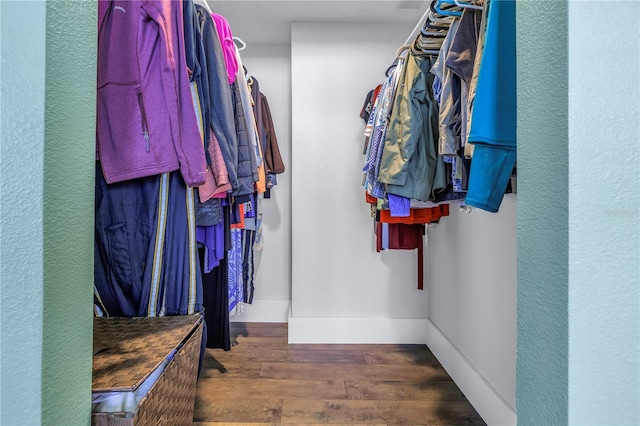 spacious closet with dark hardwood / wood-style floors