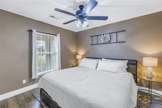 bedroom with ceiling fan and dark hardwood / wood-style floors