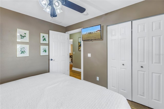 bedroom with ceiling fan and a closet