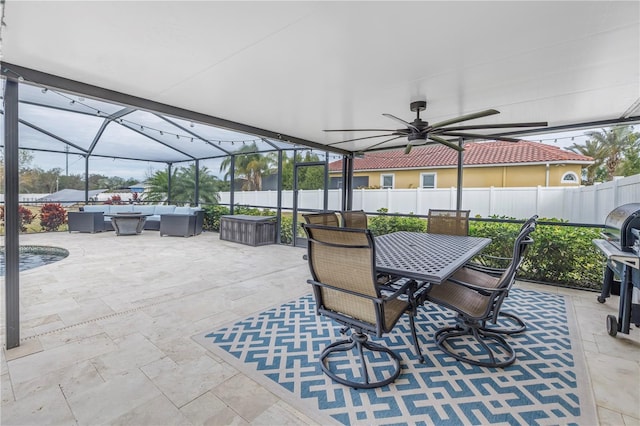 view of patio / terrace with ceiling fan, an outdoor living space, and glass enclosure