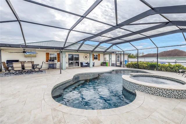 view of pool featuring an in ground hot tub, a patio area, and glass enclosure