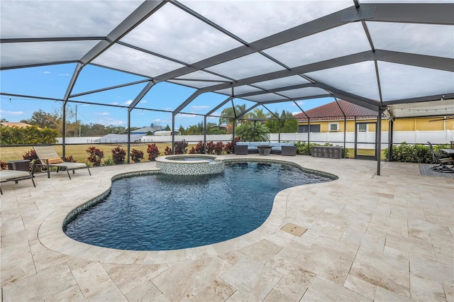 view of pool featuring a patio, glass enclosure, and an in ground hot tub