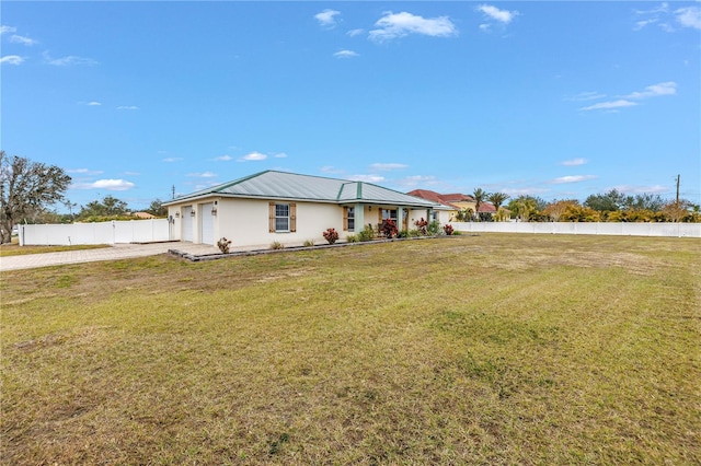 single story home featuring a front lawn, metal roof, fence, and stucco siding