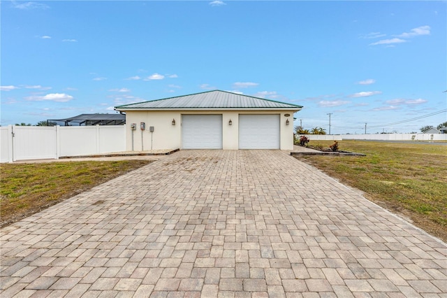 garage featuring a lawn