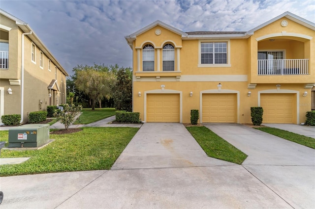 view of property featuring a front lawn and a garage