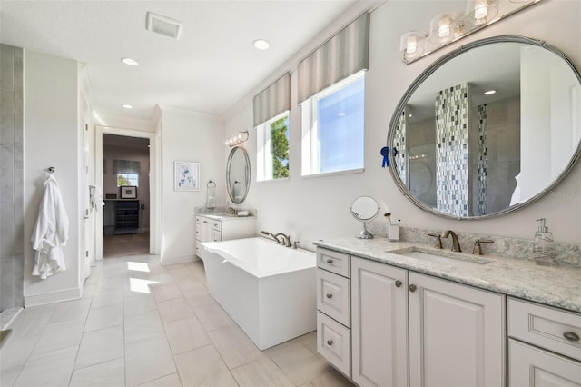 bathroom with plus walk in shower, vanity, tile patterned floors, and crown molding