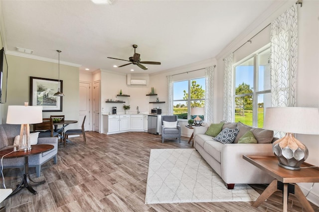 living room featuring ceiling fan, crown molding, a wall mounted air conditioner, and light wood-type flooring