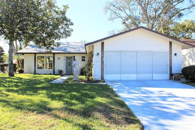 single story home featuring a front yard and a garage