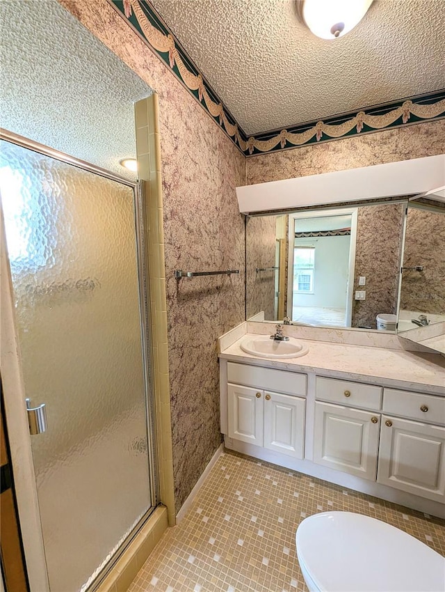 bathroom featuring vanity, tile patterned flooring, toilet, a textured ceiling, and a shower with shower door