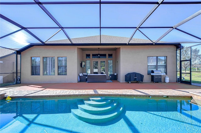 outdoor pool with glass enclosure, a patio area, french doors, and a grill