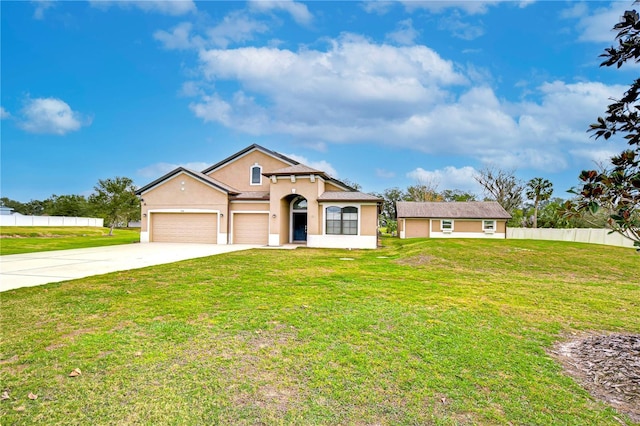 mediterranean / spanish house featuring driveway, an attached garage, a front lawn, and fence