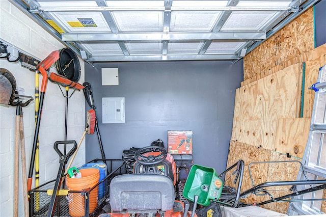 garage featuring electric panel and concrete block wall