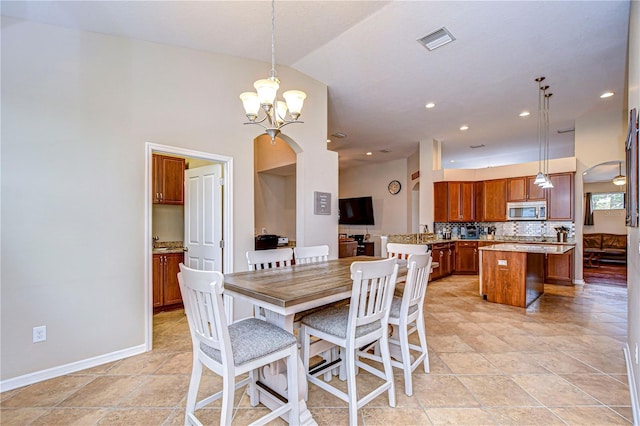 dining space featuring visible vents, baseboards, recessed lighting, arched walkways, and vaulted ceiling