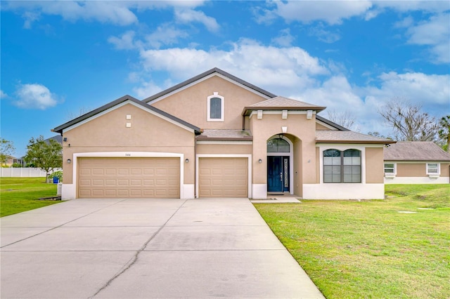 mediterranean / spanish home with a shingled roof, a front lawn, concrete driveway, and stucco siding