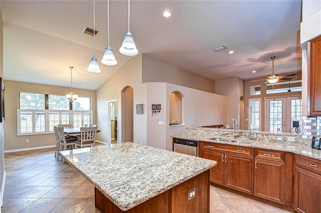 kitchen with light tile patterned floors, arched walkways, visible vents, dishwasher, and a sink