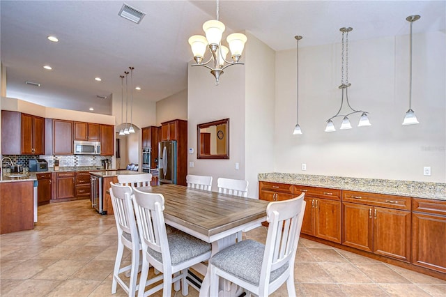 dining area with a chandelier, light tile patterned floors, visible vents, and recessed lighting