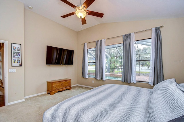 carpeted bedroom featuring baseboards, vaulted ceiling, and ceiling fan