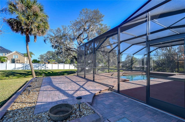 view of patio / terrace with a fenced backyard, a fenced in pool, and glass enclosure