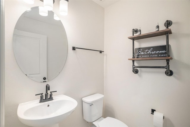 bathroom featuring sink and toilet