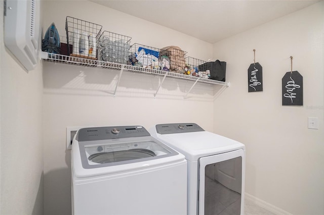 clothes washing area featuring separate washer and dryer