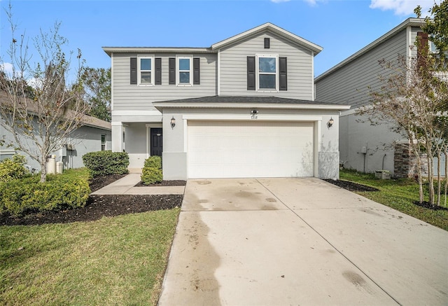 view of property featuring a garage and a front lawn