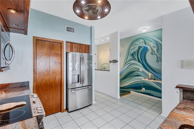 kitchen featuring light tile patterned floors and stainless steel appliances