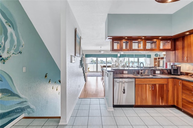 kitchen featuring ceiling fan, dishwasher, light tile patterned floors, and sink