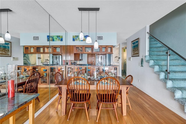 dining space with light hardwood / wood-style flooring