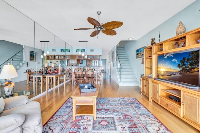 living room featuring ceiling fan and light hardwood / wood-style flooring